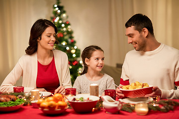 Image showing happy family having christmas dinner at home