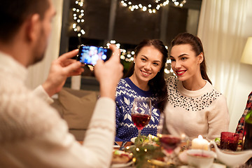Image showing friends having christmas dinner and taking picture