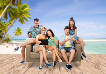 Image showing friends with tablet pc and smartphones over beach