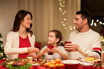 Image showing happy family having christmas dinner at home