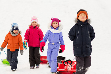 Image showing happy little kids with sleds in winter