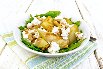 Image showing Salad from pear and spinach in dish on light board