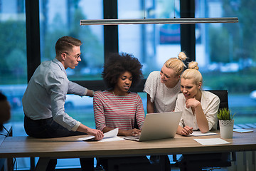 Image showing Multiethnic startup business team in night office