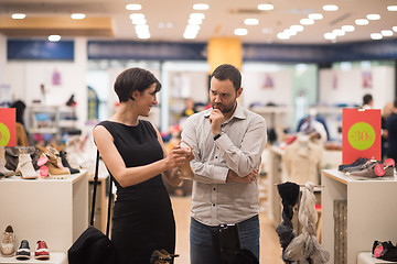 Image showing couple chooses shoes At Shoe Store