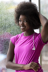 Image showing portrait of young afro american woman in gym while listening mus