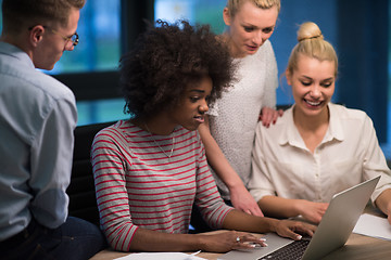 Image showing Multiethnic startup business team in night office