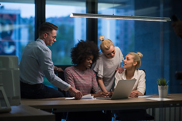 Image showing Multiethnic startup business team in night office