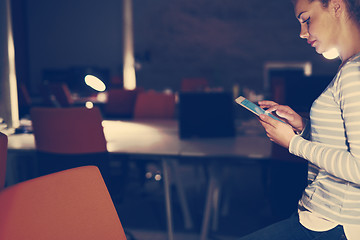 Image showing woman working on digital tablet in night office