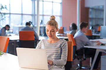 Image showing businesswoman using a laptop in startup office