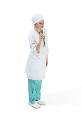 Image showing Beautiful young woman in white coat posing at studio. Full length studio shot isolated on white.