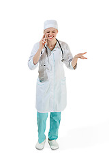 Image showing Beautiful young woman in white coat posing at studio. Full length studio shot isolated on white.