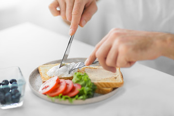 Image showing close up of man having toasts for breakfast