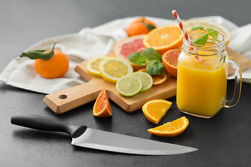 Image showing mason jar glass with juice and fruits on table