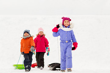 Image showing happy little kids with sleds in winter