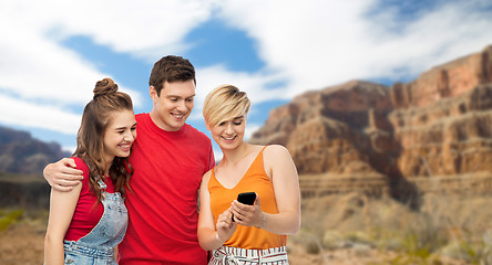 Image showing friends with smartphone over grand canyon