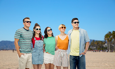 Image showing happy friends in sunglasses over venice beach