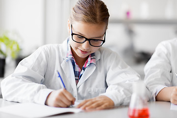 Image showing girl studying chemistry at school laboratory
