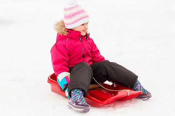 Image showing happy little girl on sled outdoors in winter