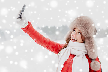 Image showing happy woman taking selfie outdoors in winter