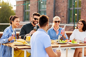 Image showing happy friends with drinks at rooftop party