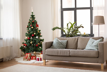Image showing christmas tree, gifts and sofa at cozy home