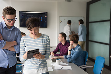 Image showing Two Business People Working With Tablet in office