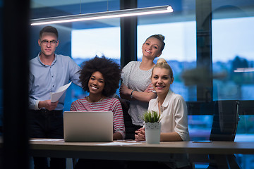 Image showing Multiethnic startup business team in night office