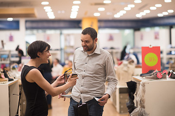 Image showing couple chooses shoes At Shoe Store