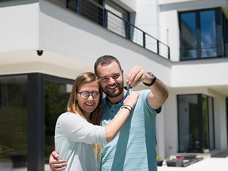 Image showing couple hugging in front of  new luxury home