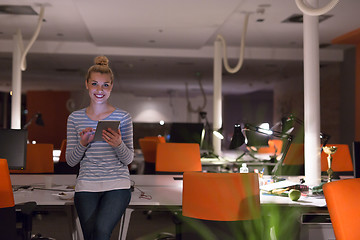 Image showing woman working on digital tablet in night office