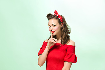 Image showing Beautiful young woman with pinup make-up and hairstyle. Studio shot on white background