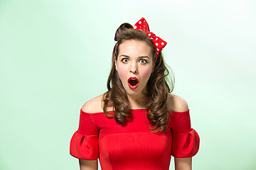 Image showing Beautiful young woman with pinup make-up and hairstyle. Studio shot on white background