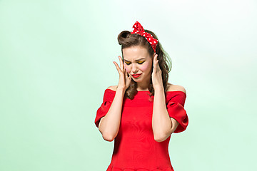 Image showing Beautiful young woman with pinup make-up and hairstyle. Studio shot on white background