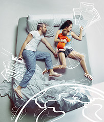 Image showing Top view of happy family with one newborn child in bedroom and their dreams .