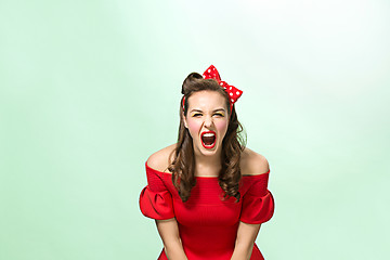 Image showing Beautiful young woman with pinup make-up and hairstyle. Studio shot on white background