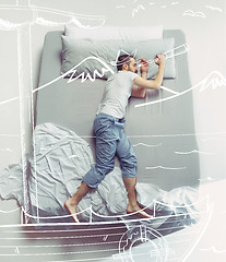 Image showing Top view photo of young man sleeping in a big white bed and his dreams.