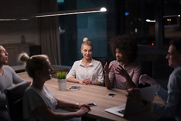 Image showing Multiethnic startup business team in night office