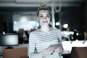 Image showing woman working on digital tablet in night office