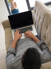 Image showing Man using laptop in living room