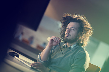 Image showing man working on computer in dark office