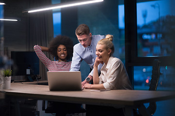 Image showing Multiethnic startup business team in night office