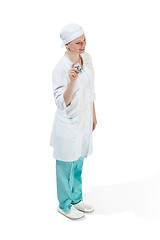 Image showing Beautiful young woman in white coat posing at studio. Full length studio shot isolated on white.