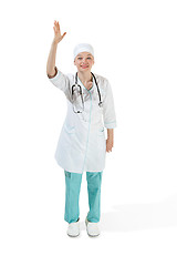 Image showing Beautiful young woman in white coat posing at studio. Full length studio shot isolated on white.