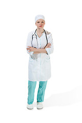 Image showing Beautiful young woman is standing seriously in white coat posing at studio. Full length studio shot isolated on white.