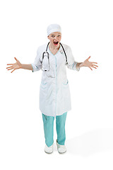 Image showing Beautiful young woman is surprised in white coat posing at studio. Full length studio shot isolated on white.