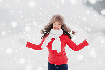 Image showing happy smiling woman in winter fur hat outdoors