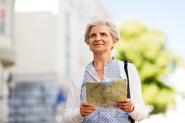 Image showing senior woman or tourist with map on city street