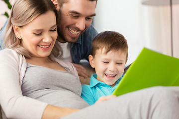 Image showing happy family reading book at home