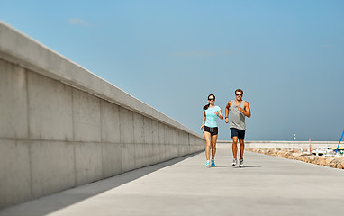 Image showing couple in sports clothes running outdoors