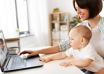 Image showing mother with baby having video chat with doctor